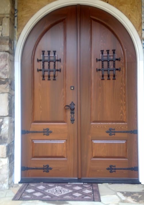 arched top double doors with iron strap hinges